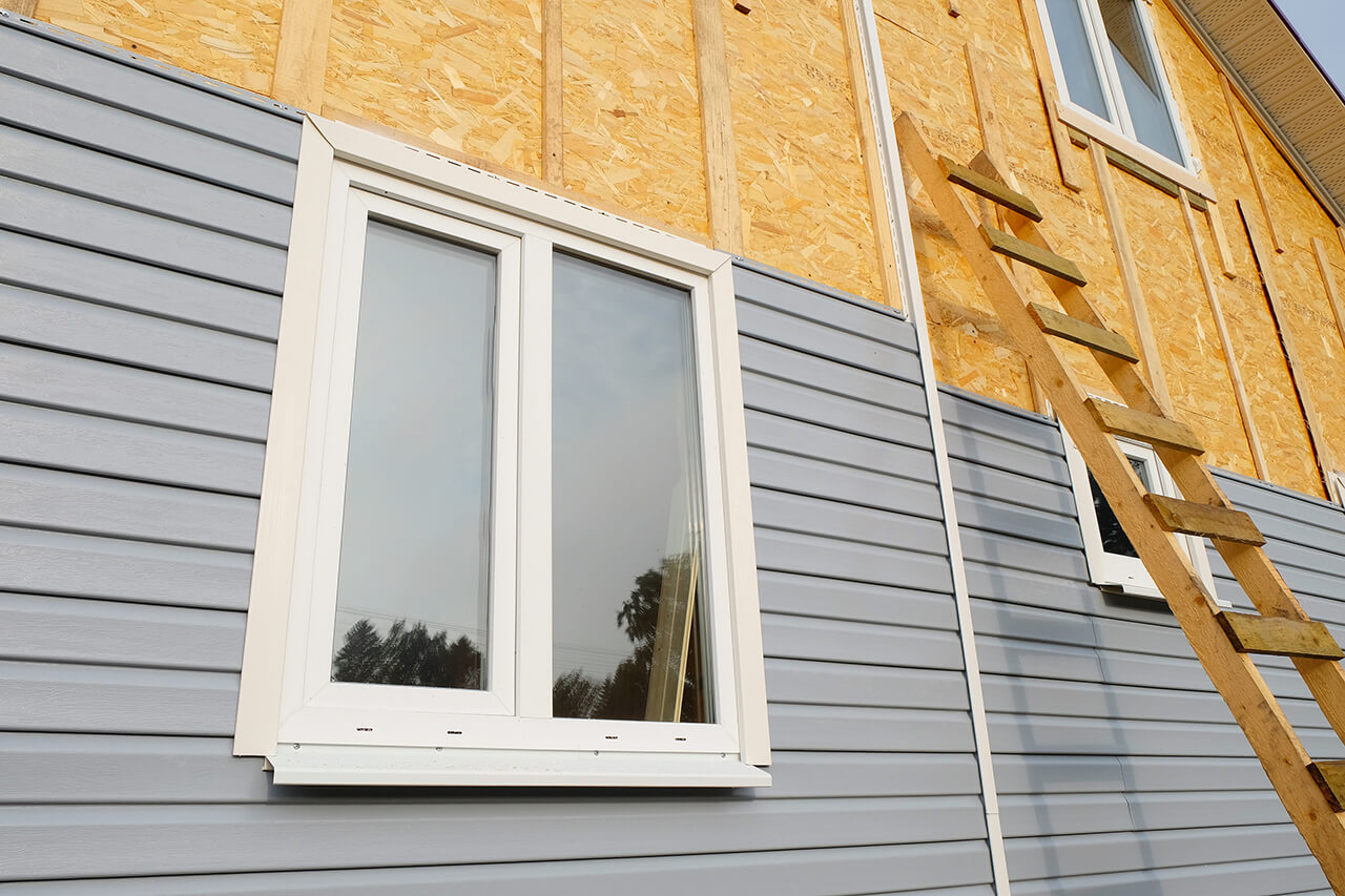 vinyl siding being replaced on exterior of a house