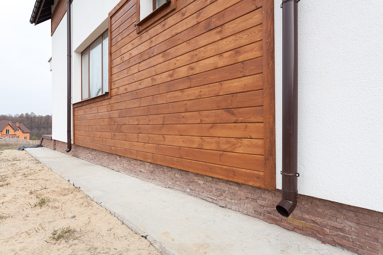 new home construction with wood siding installed