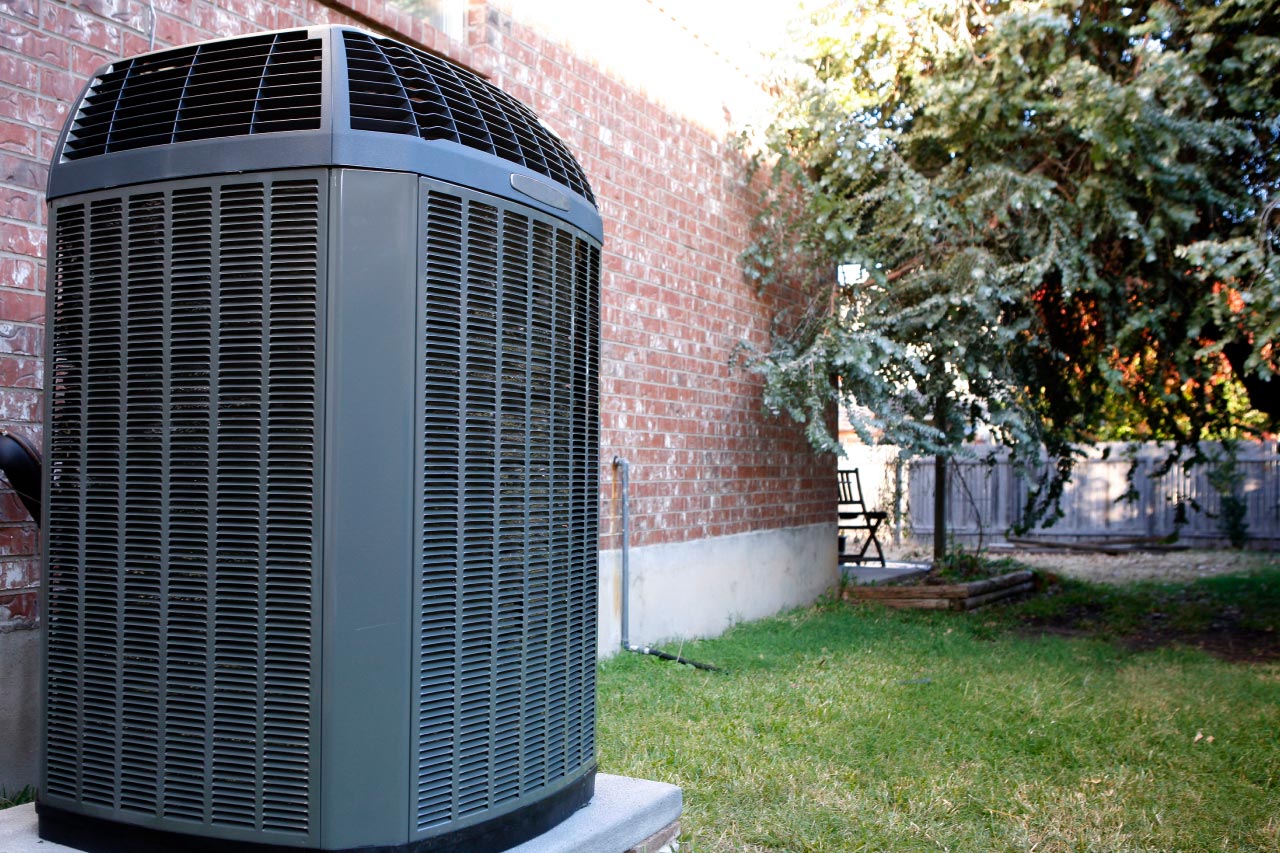 An AC system in the backyard of a house