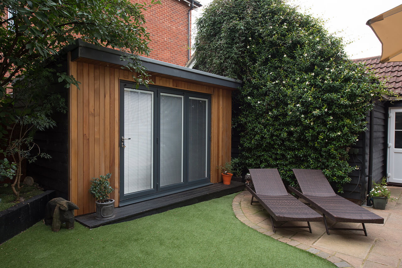 modern home with artifical turf lawn in backyard