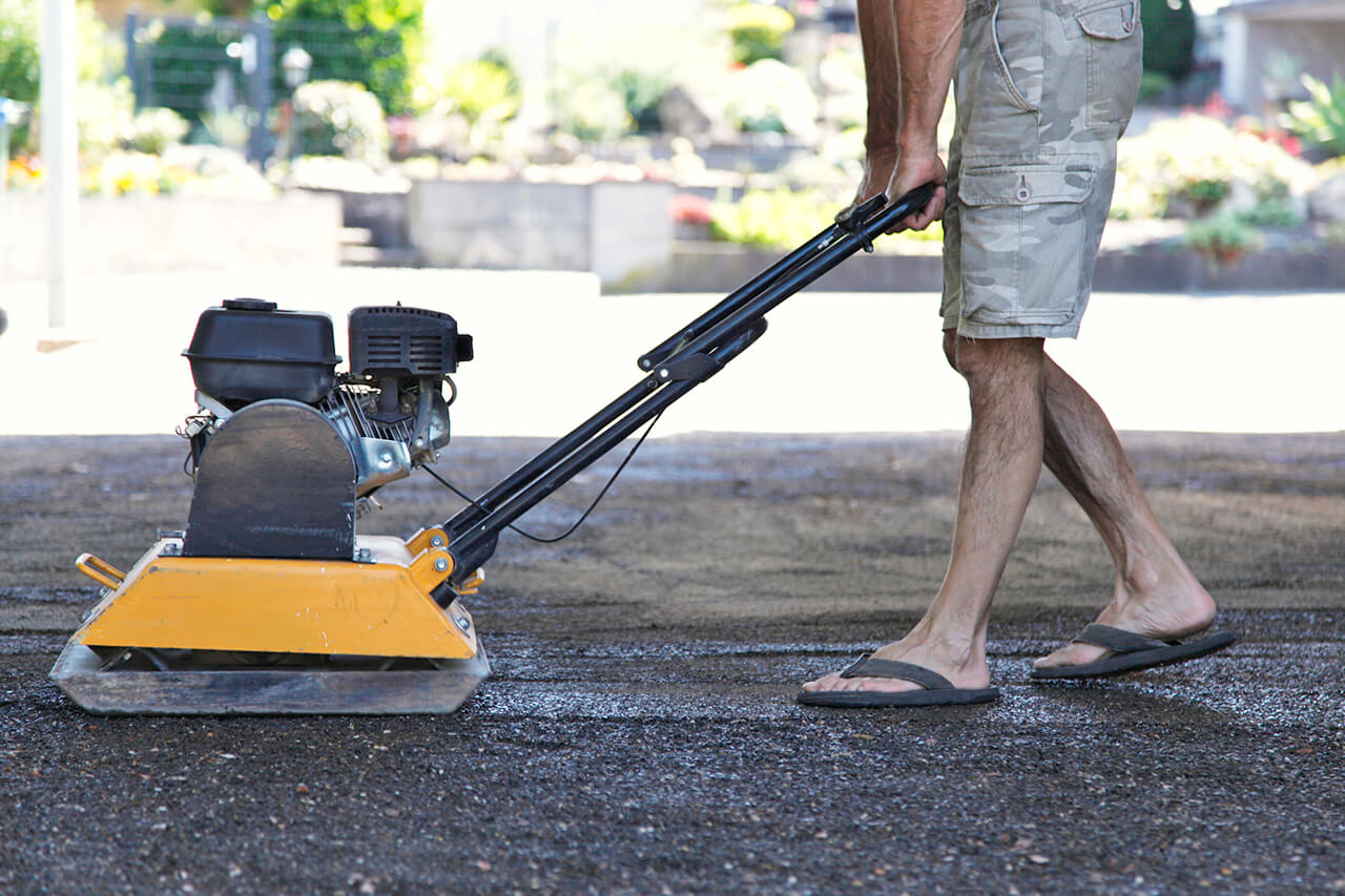 asphalt paving being repaired in front of home