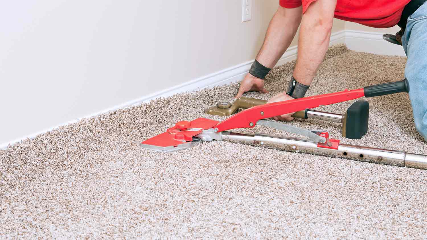 man stretching beige carpet