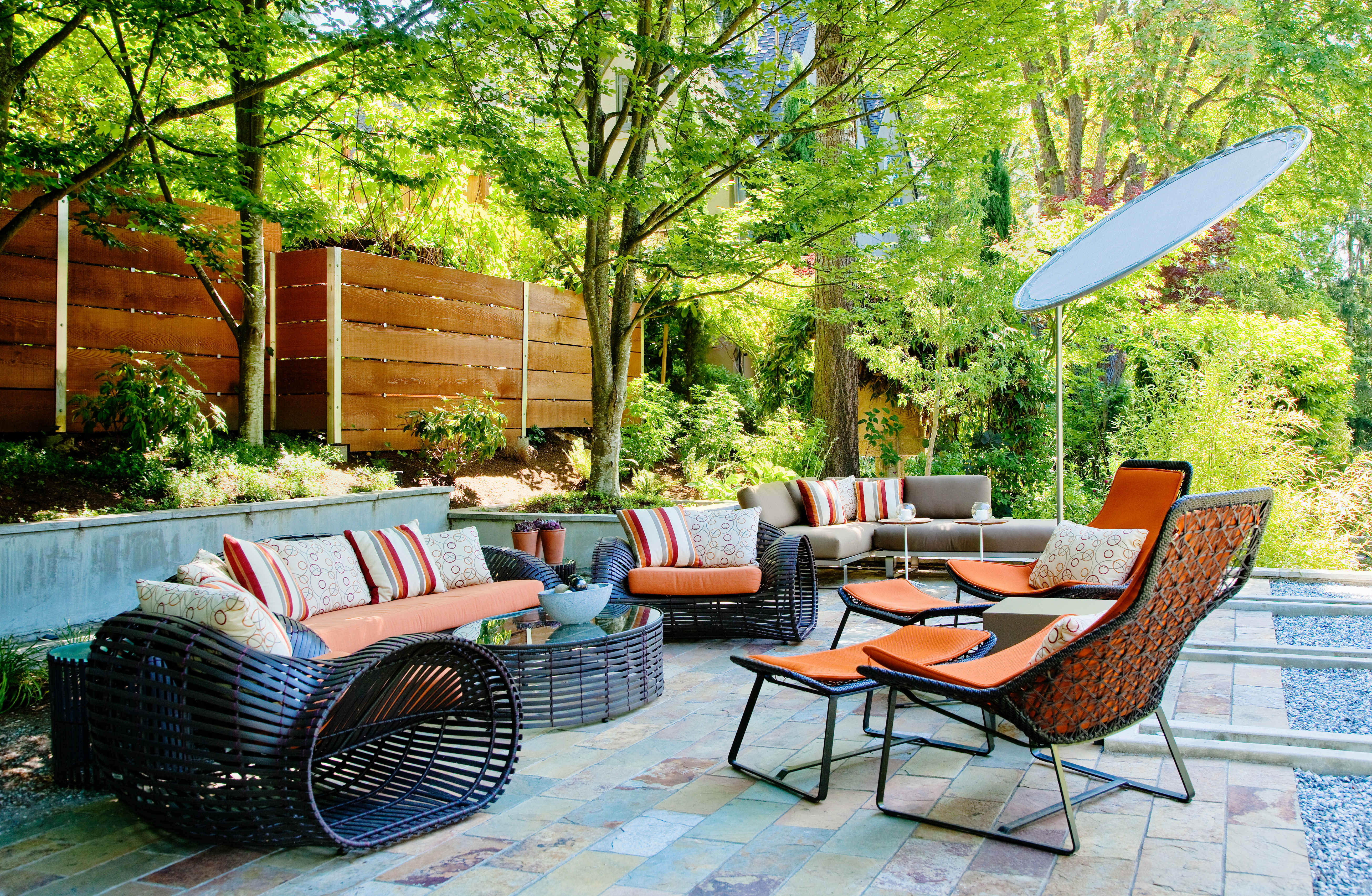 Cozy patio living room with comfortable furniture and decorative plants, creating an inviting outdoor space for relaxation