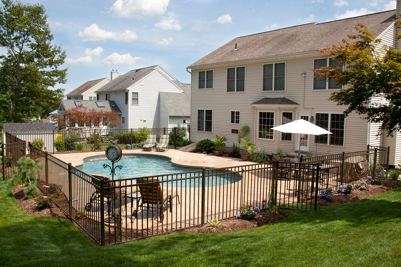 metal fence around swimming pool in backyard