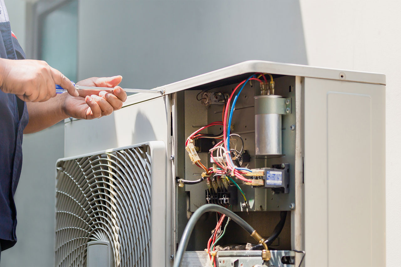 Technician repairing air conditioner